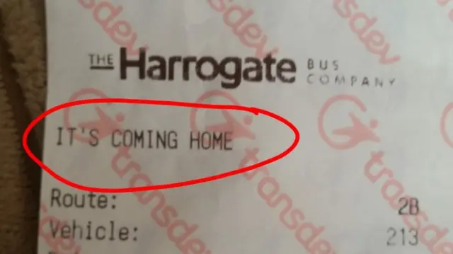 Bus ticket with 'It's coming home' written on it