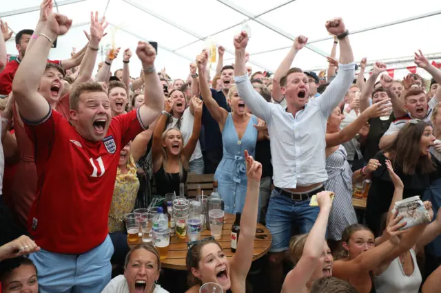 England fans celebrate Alli's goal