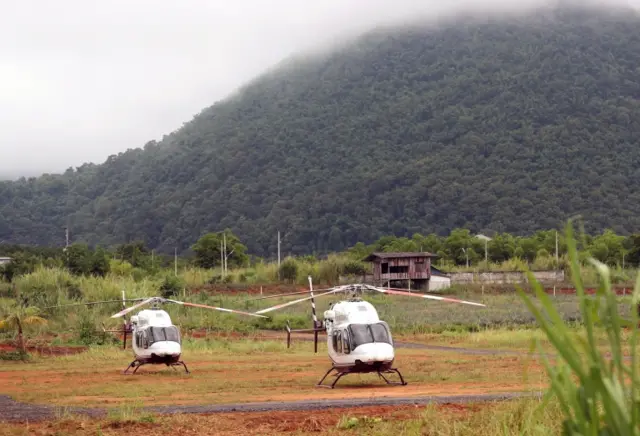 Helicopters on a stand by near the cave