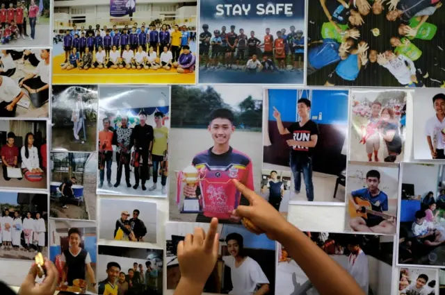 Children at Mesai Grace Church, Chiang Rai province, look  at pictures of some of the trapped boys