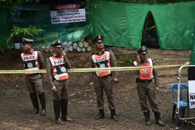 Thai police stand guard at the Tham Luang cave area