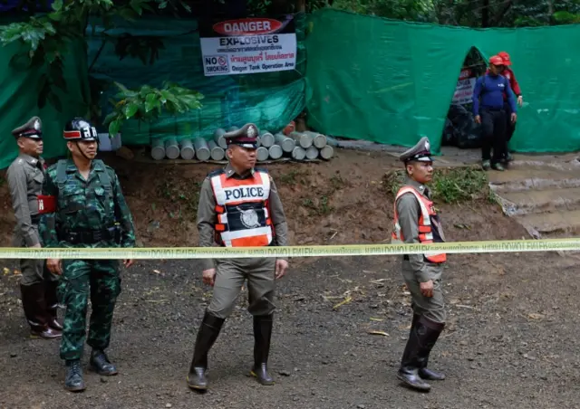 Thai police guard the area around the cave