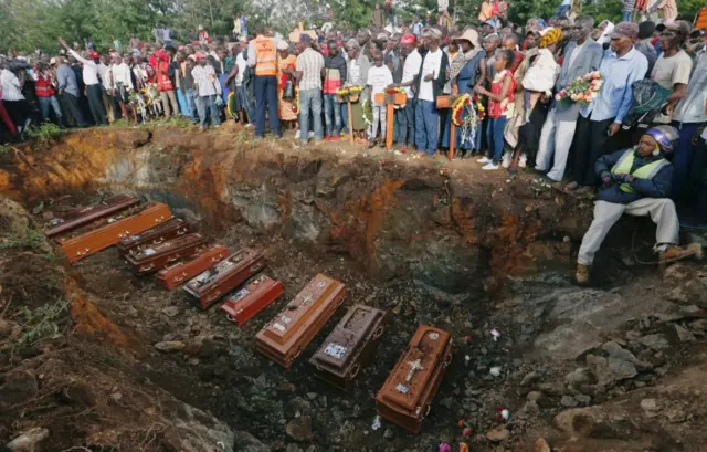 Coffins are seen arranged inside a mass grave during the burial of people killed when a dam burst its walls, overrunning nearby homes, in Solai town near Nakuru, Kenya May 16, 2018