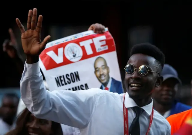 A supporter of the opposition Movement for Democratic Change party (MDC) of Nelson Chamisa, gestures outside the partys headquarters following general elections in Harare, Zimbabwe, July 31, 2018.