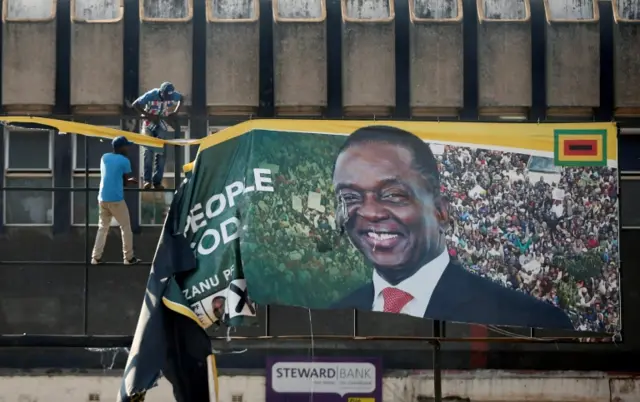 An election banner with the face of Zimbabwe's President Emmerson Mnangagwa has been removed in Harare by supporters of opposition presidential candidate Nelson Chamisa.