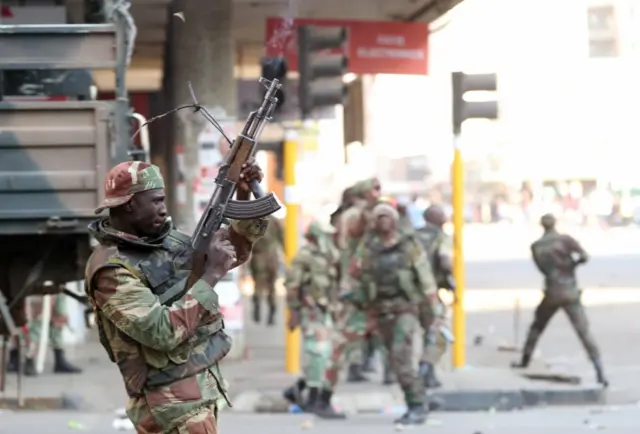 Soldiers open fire to disperse crowds of the opposition Movement for Democratic Change supporters outside the party"s headquarters in Harare, Zimbabwe, August 1, 2018