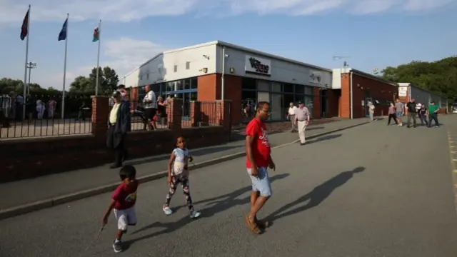 Fans arriving at The New Saints stadium for a match