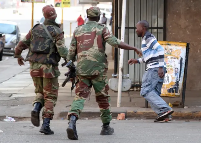 Soldiers disperse crowds of the opposition Movement for Democratic Change supporters outside the party"s headquarters in Harare, Zimbabwe, August 1, 2018