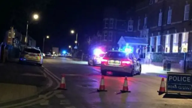 Police cars and cones at scene of accident on Queen Street