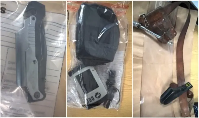 Close up of pocket knife, pouch and a satellite navigation system and a work belt