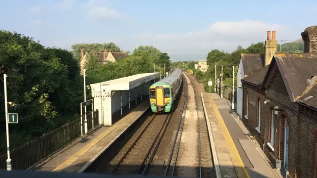 Southern train calling at Glynde station on a sunny morning