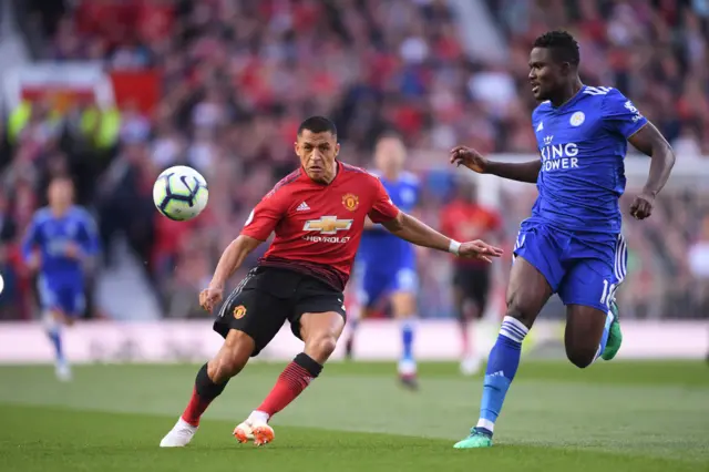 Alexis Sanchez of Manchester United battles for possession with Daniel Amartey of Leicester City