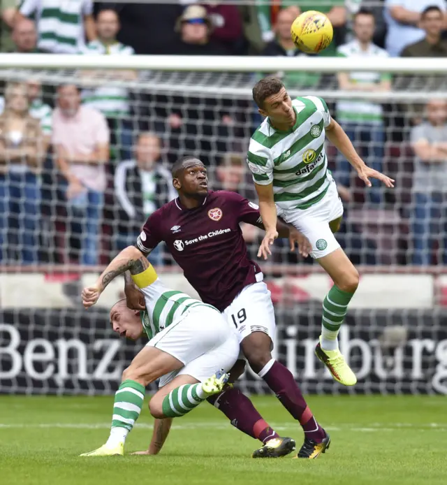 Jozo Simunovic leaps above Uche Ikpeazu to head the ball away