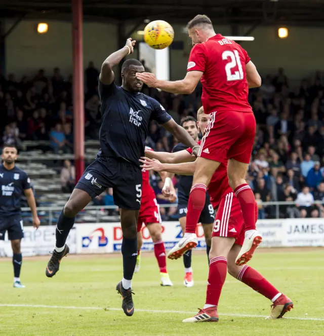 Dundee's Genseric Kusunga blocks Dom Balls' header with his hand