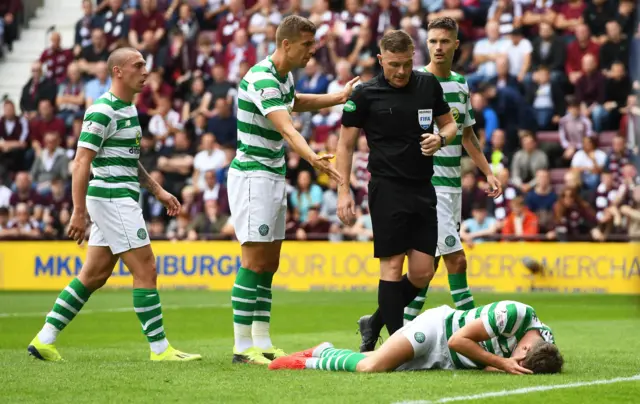 Jack Hendry lies on the ground holding his head