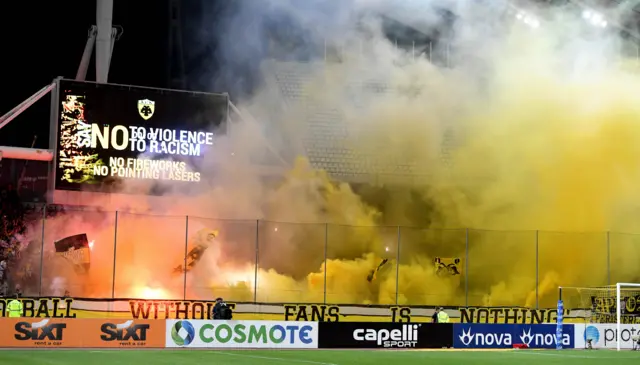 Smoke bombs go off in the Olympic Stadium before kick off