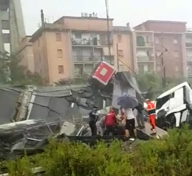 A cluster of people work on the rubble of the stream