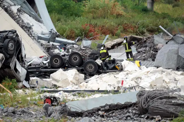 Rescuers at work amid the rubble