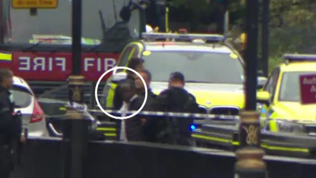 Man being detained outside Houses of Parliament