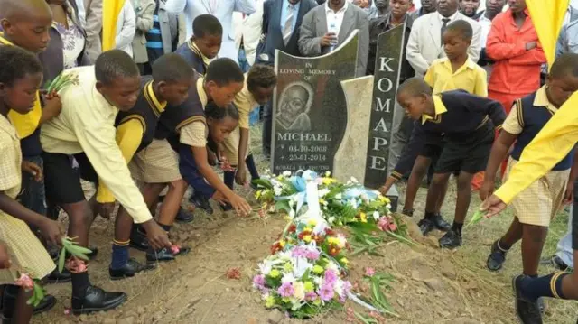 Children dressed in school uniforms pay their respects at Michael Komape's funeral