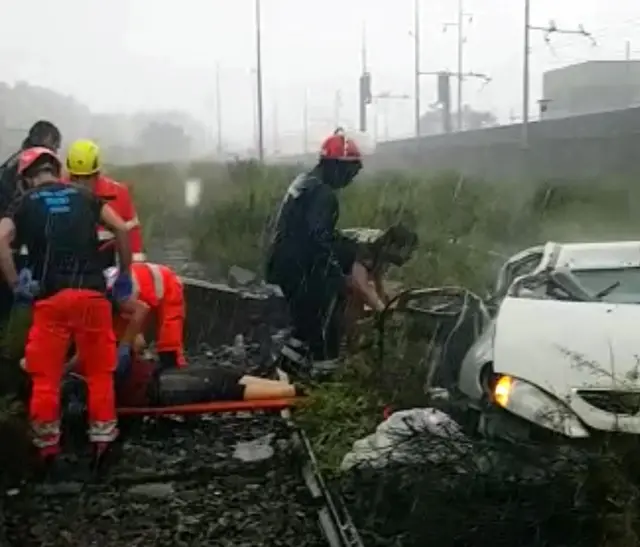 Rescue workers tend to a woman, whose face and identity are obscured, is tended to on a stretcher