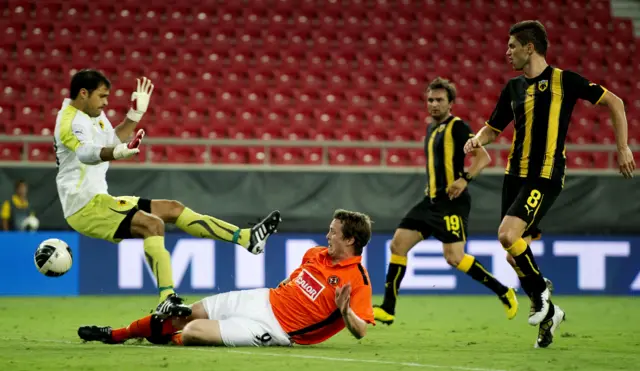 Jon Daly slides in to score for Dundee United in a 1-1 draw at a near-empty Georgios Karaiskakis Stadium