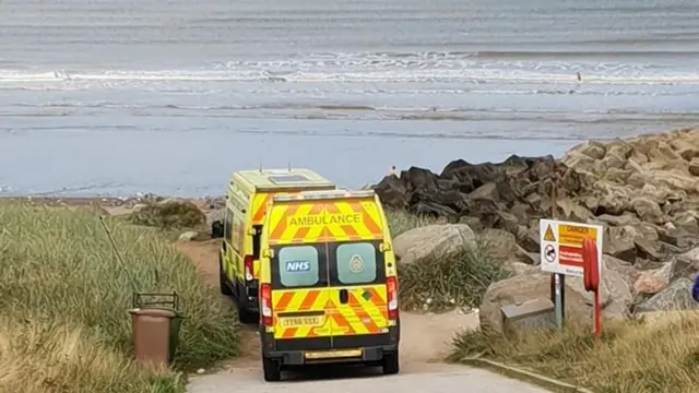 Two ambulances by seafront