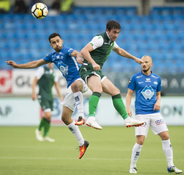 Hibernian's Stevie Mallan competes for a header with Molde's Etzaz Hussain