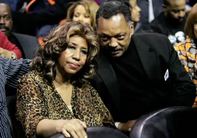 Singer Aretha Franklin (L) sits courtside with Reverend Jesse Jackson during the NBA basketball game between the Detroit Pistons and Miami Heat in Auburn Hills, Michigan in this February 11, 2011