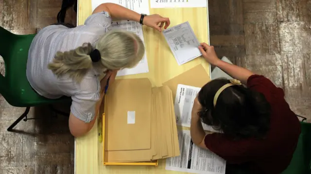 A person receives her a-level results