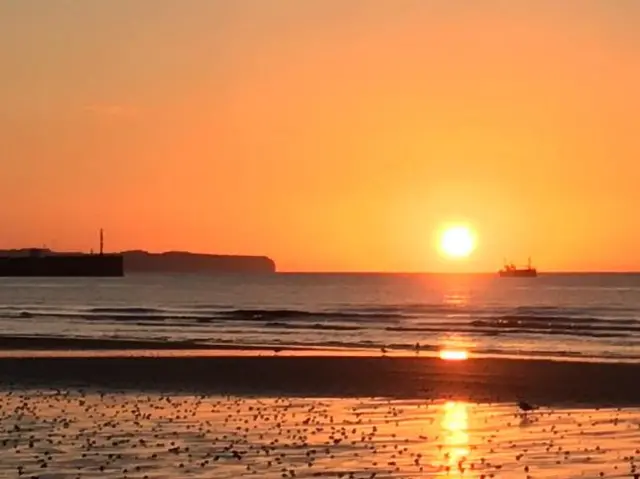 Beach and boat and sunrise in Bridlington