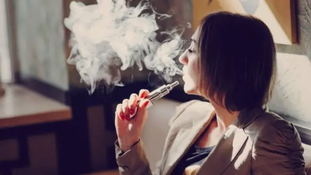 Woman using an e-cigarette