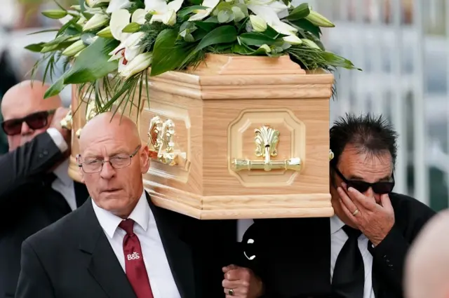 Paul Chuckle carries the coffin of his brother Barry