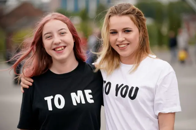 Two girls with t shirts on with catchphrase