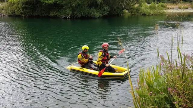 Dog being paddled back to safety