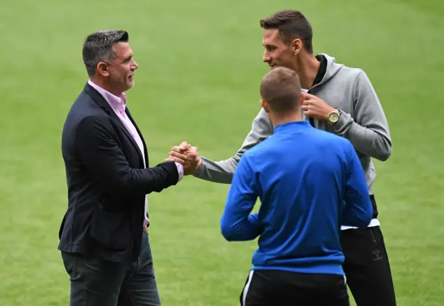 Osijek manager Zoran Zekic shakes hands with Rangers Croatia defender Nikola Katic