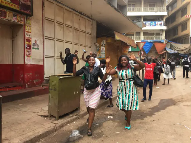 People emerged from malls and shops with their hands up in the air after security forces arrived