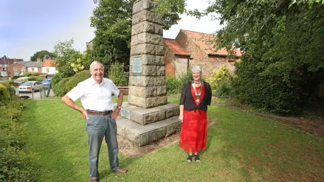 Two people stand in the memorial garden