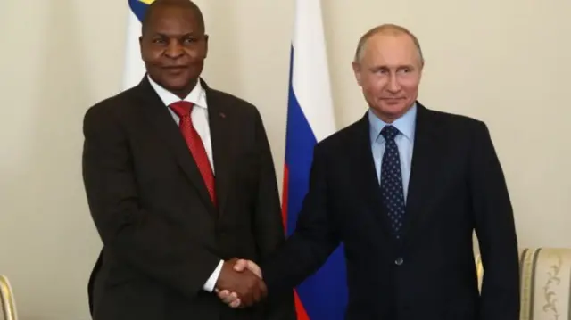 CAR President Faustin-Archange Touadera (L) and Russia's President Vladimir Putin shake hands during a meeting in St Petersburg - May 2018