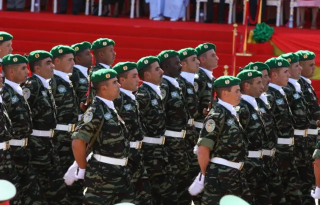 Morocco soldiers march past the official stand during a military parade in Bobo Dioulasso on December 11, 2010