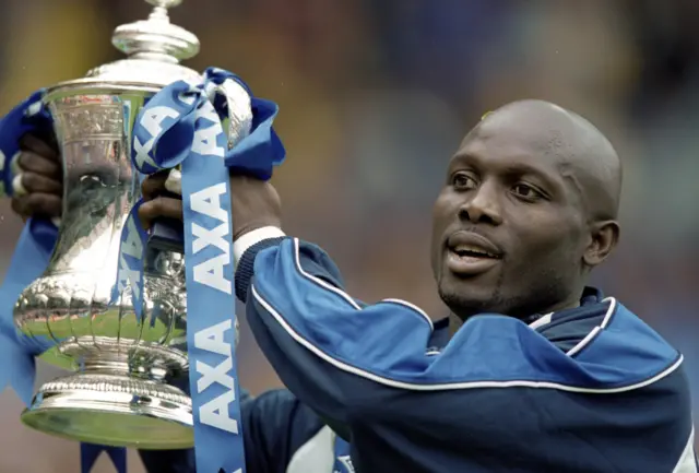 George Weah pictured lifting the FA cup in 2000