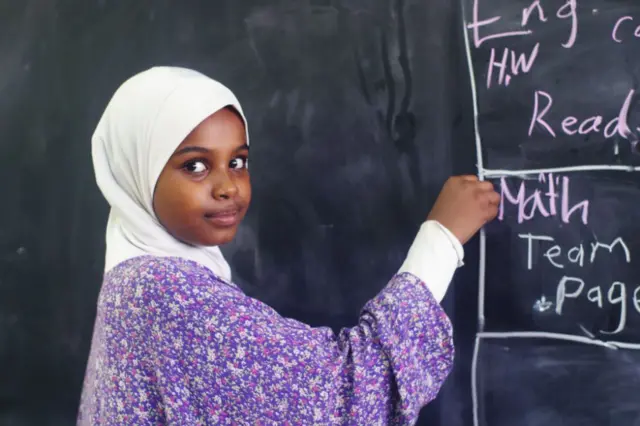 Young girl at a blackboard