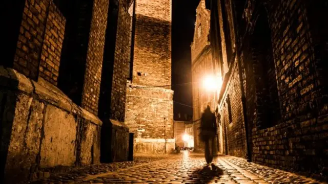 Generic image of person walking in dark street