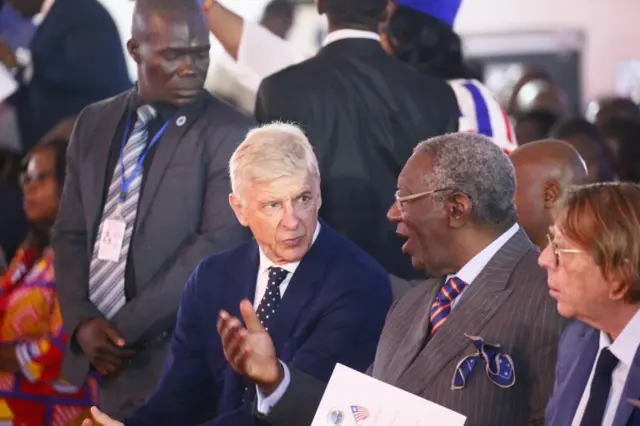 Former Ghanaian President, John Kuffour (C-R), chats with former Arsenal Coach, Arsene Wenger (C-L) at the induction ceremony of the Order of Distinction and Knight Grand Commander of the Humane Order of African Redemption at the Samuel Kanyon Doe Sports Complex, Paynesville, outside Monrovia, Liberia