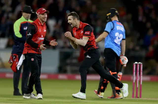 Mark Wood of Durham Jets (C) celebrates taking the wicket of Delray Rawlins of Sussex Sharks