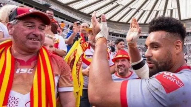 Dragons winger Jodie Broughton celebrates with the Catalans fans