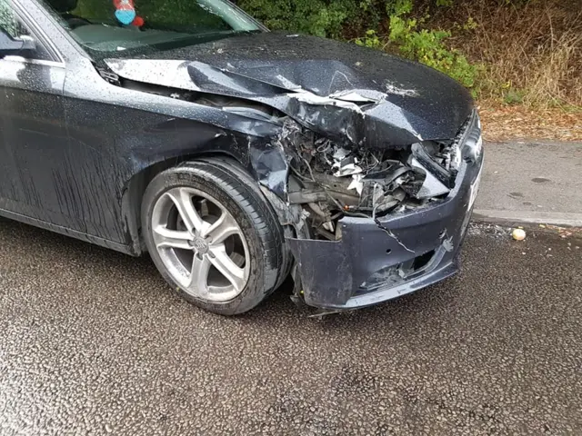 A damaged blue Audi A4