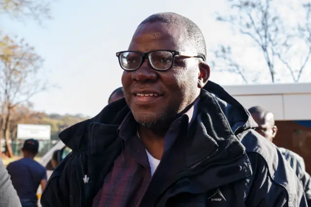 Zimbabwe leading opposition figures Tendai Biti of Zimbabwe's main opposition Movement for Democratic Change arrives in handcuffs at the Harare Magistrates court August 9, 2018