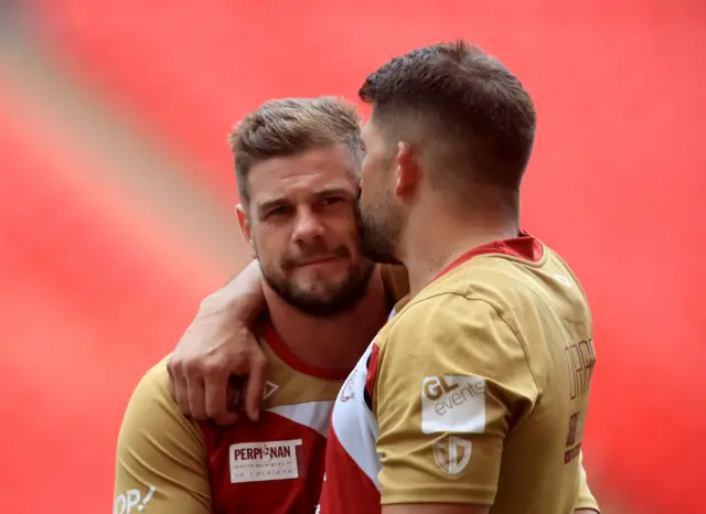 Catalan Dragons' Capatin Remi Casty gets a kiss off team mate Mickael Simon