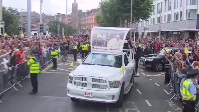 Pope Francis waves from the Popemobile